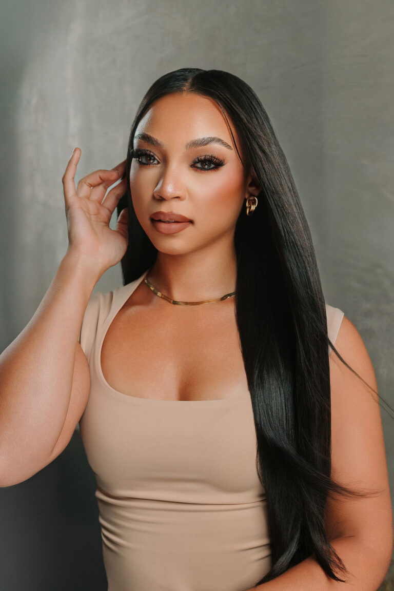 Model with long, sleek straight black hair styled by Metoyer Coiffure