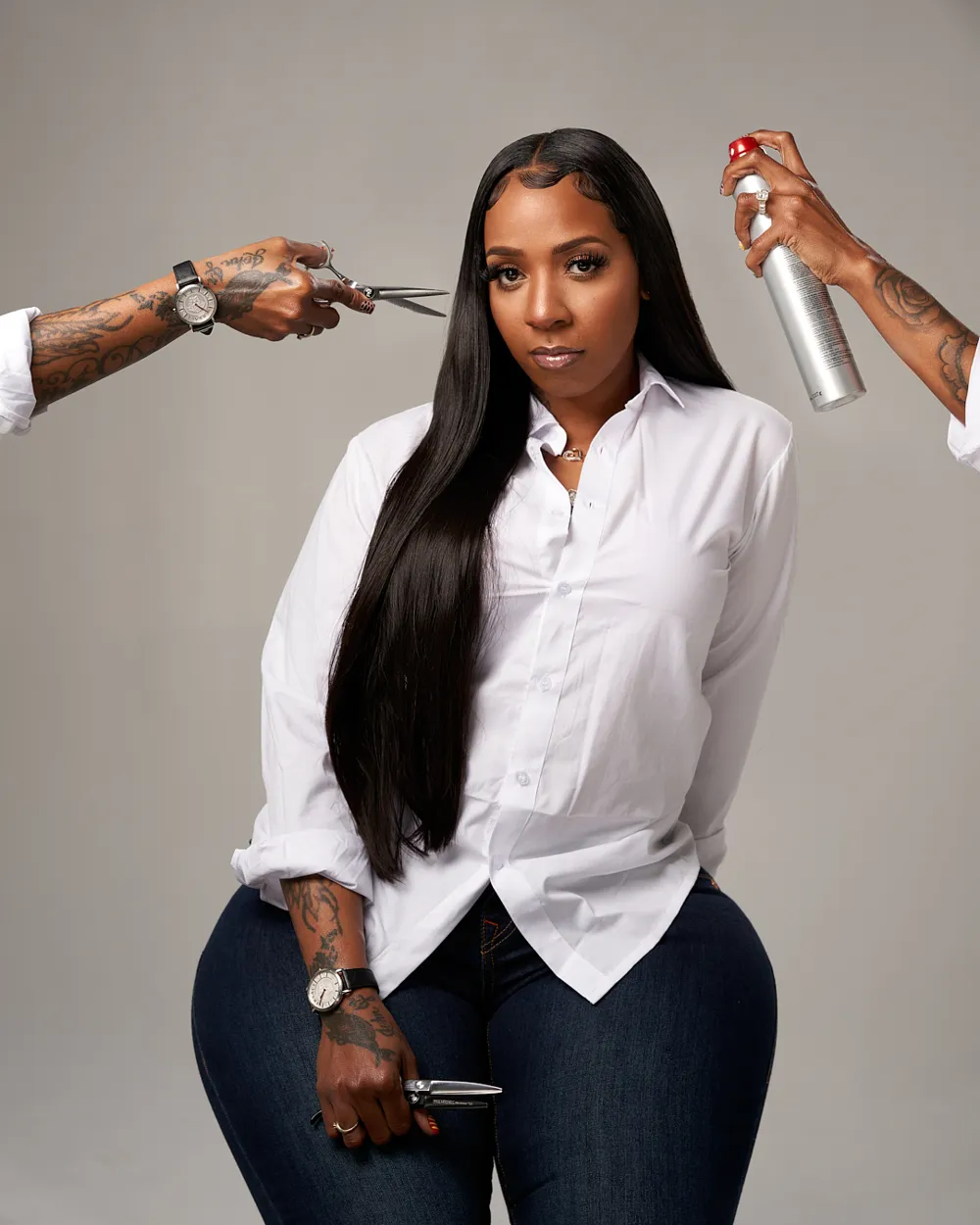 Nykima Metoyer, stylist and owner of Metoyer Coiffure, holding shears and hairspray